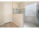 Modern bathroom with a walk-in shower, glass enclosure, and a large window at 20642 N 268Th Dr, Buckeye, AZ 85396