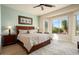 Bright bedroom with a king-size bed and large window offering scenic views at 20642 N 268Th Dr, Buckeye, AZ 85396