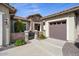 Front entrance with stone accents, two-car garage, and mature landscaping at 20642 N 268Th Dr, Buckeye, AZ 85396