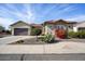 Single-story home with terracotta tile roof, desert landscaping, and a two-car garage at 20642 N 268Th Dr, Buckeye, AZ 85396