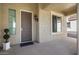 Gray front door with sidelights and a small porch at 20642 N 268Th Dr, Buckeye, AZ 85396