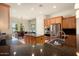 Modern kitchen with granite countertops and wood cabinets at 20642 N 268Th Dr, Buckeye, AZ 85396