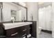 Bathroom with a dual sink vanity and a walk-in shower featuring neutral color palette at 211 E Dawn Dr, Tempe, AZ 85284