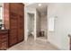 Bright bathroom featuring a modern shower, toilet room, and dark wood cabinets with black countertop at 211 E Dawn Dr, Tempe, AZ 85284