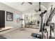 Spacious fitness room featuring multiple exercise machines, a mirror, and ample space at 211 E Dawn Dr, Tempe, AZ 85284