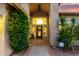 Inviting front entrance with covered porch, decorative plants, and a stylish front door with sidelights and transom at 211 E Dawn Dr, Tempe, AZ 85284