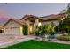 Well-manicured front yard featuring lush green lawn, desert landscaping, mature trees, and a charming one-story home at 211 E Dawn Dr, Tempe, AZ 85284