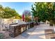 Outdoor kitchen area with a built-in grill and counter space, perfect for outdoor cooking and entertaining at 211 E Dawn Dr, Tempe, AZ 85284