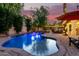 Inviting pool with a waterfall feature and a comfortable seating area for outdoor relaxation at 211 E Dawn Dr, Tempe, AZ 85284