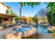 Backyard pool and spa area with a patio, built-in barbecue, and lush landscaping, perfect for outdoor entertaining at 211 E Dawn Dr, Tempe, AZ 85284