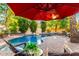 Backyard swimming pool surrounded by lounge chairs and lush landscaping, perfect for relaxation and recreation at 211 E Dawn Dr, Tempe, AZ 85284