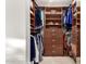 Spacious walk-in closet with built-in shelving, drawers, hanging rods, and a full-length mirror at 211 E Dawn Dr, Tempe, AZ 85284