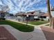 View of the condo community showcasing green lawns, sidewalks, and the community pool at 220 N 22Nd Pl # 2059, Mesa, AZ 85213