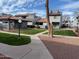 Exterior shot of the condo community with well-kept landscaping, sidewalks and buildings at 220 N 22Nd Pl # 2059, Mesa, AZ 85213