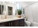 Modern bathroom with dark brown vanity, white countertop, and a shower at 23393 N 73Rd Way, Scottsdale, AZ 85255