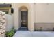 Stylish front door with arched entryway and stone accents at 23393 N 73Rd Way, Scottsdale, AZ 85255