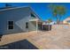 Backyard with a covered patio, brick pavers, and gravel at 235 N 22Nd Pl # 565, Mesa, AZ 85213