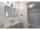 Updated bathroom with stylish vanity, modern mirror and lighting, and a shower-tub combo at 235 N 22Nd Pl # 565, Mesa, AZ 85213