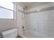 Bathroom features a window and a shower-tub combo with white and grey tiles at 235 N 22Nd Pl # 565, Mesa, AZ 85213