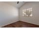 Bedroom featuring wood floors, a window for natural light, and a ceiling fan at 235 N 22Nd Pl # 565, Mesa, AZ 85213