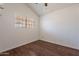 Bedroom with wood floors, vaulted ceiling with fan, and a window offering natural light at 235 N 22Nd Pl # 565, Mesa, AZ 85213