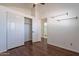 Bright bedroom with wood floors, closet, and ensuite bathroom at 235 N 22Nd Pl # 565, Mesa, AZ 85213