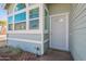 Close-up of a light blue home's front door and corner windows at 235 N 22Nd Pl # 565, Mesa, AZ 85213