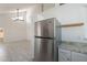 Kitchen featuring stainless refrigerator, tile floors and stone countertops at 235 N 22Nd Pl # 565, Mesa, AZ 85213