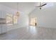 Bright living room featuring vaulted ceilings, stylish pendant lighting, and sliding glass doors at 235 N 22Nd Pl # 565, Mesa, AZ 85213