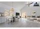 A staged, bright living room featuring vaulted ceilings, stylish pendant lighting, and furniture at 235 N 22Nd Pl # 565, Mesa, AZ 85213