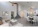 Staged living area with vaulted ceilings, modern fan, and seamless flow to the kitchen area at 235 N 22Nd Pl # 565, Mesa, AZ 85213