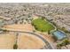 Aerial view of a community park featuring green space, playground, and tennis courts surrounded by homes at 2637 S Sandstone St, Gilbert, AZ 85295