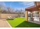 This backyard features a kidney-shaped pool, artificial turf, covered patio and fire pit at 2637 S Sandstone St, Gilbert, AZ 85295