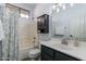 Bathroom features a shower-tub combo, vanity with sink and mirror, and a cabinet for storage at 2637 S Sandstone St, Gilbert, AZ 85295