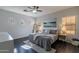 Cozy bedroom featuring a ceiling fan, natural light, and a neutral color palette with wood flooring at 2637 S Sandstone St, Gilbert, AZ 85295