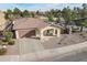 Charming single-story home boasts a desert landscape, covered porch with seating, and attached garage at 2637 S Sandstone St, Gilbert, AZ 85295