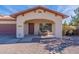 Charming covered front porch with lovely seating area and low maintenance desert landscaping at 2637 S Sandstone St, Gilbert, AZ 85295