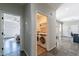 Hallway view with doorways to the laundry room and the bedroom with dark-stained wood flooring at 2637 S Sandstone St, Gilbert, AZ 85295