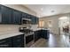 Stylish kitchen with stainless steel oven, white quartz countertops, and dark cabinetry at 2637 S Sandstone St, Gilbert, AZ 85295