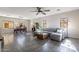 Open-concept living room featuring tile floors, a ceiling fan, and natural light from the windows at 2637 S Sandstone St, Gilbert, AZ 85295