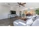 Bright living room with an open floor plan to dining area, tile floors, and comfortable sectional sofa at 2637 S Sandstone St, Gilbert, AZ 85295