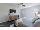 Cozy main bedroom with hardwood floors, a ceiling fan, a modern dresser, and ensuite bathroom access at 2637 S Sandstone St, Gilbert, AZ 85295