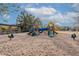 Community playground featuring slides, climbing structures, and spring riders on a sand surface at 2637 S Sandstone St, Gilbert, AZ 85295