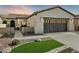 Single-story home with a two-car garage and landscaped front yard at 28107 N 123Rd Ln, Peoria, AZ 85383