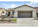 One-story home with stucco exterior, brown garage doors, and landscaped front yard at 28107 N 123Rd Ln, Peoria, AZ 85383