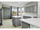 Modern kitchen with island, gray cabinets, and quartz countertops at 28107 N 123Rd Ln, Peoria, AZ 85383