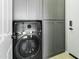 Laundry room with modern washer and dryer and gray cabinets at 28107 N 123Rd Ln, Peoria, AZ 85383