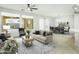 Living room with large windows, view of pool, and access to dining area at 28107 N 123Rd Ln, Peoria, AZ 85383