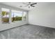 Main bedroom features a large window and plush carpet at 28107 N 123Rd Ln, Peoria, AZ 85383