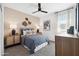 Serene bedroom featuring a comfortable bed, stylish lamps, and neutral decor for a relaxing retreat at 28242 N Nealite Dr, San Tan Valley, AZ 85143